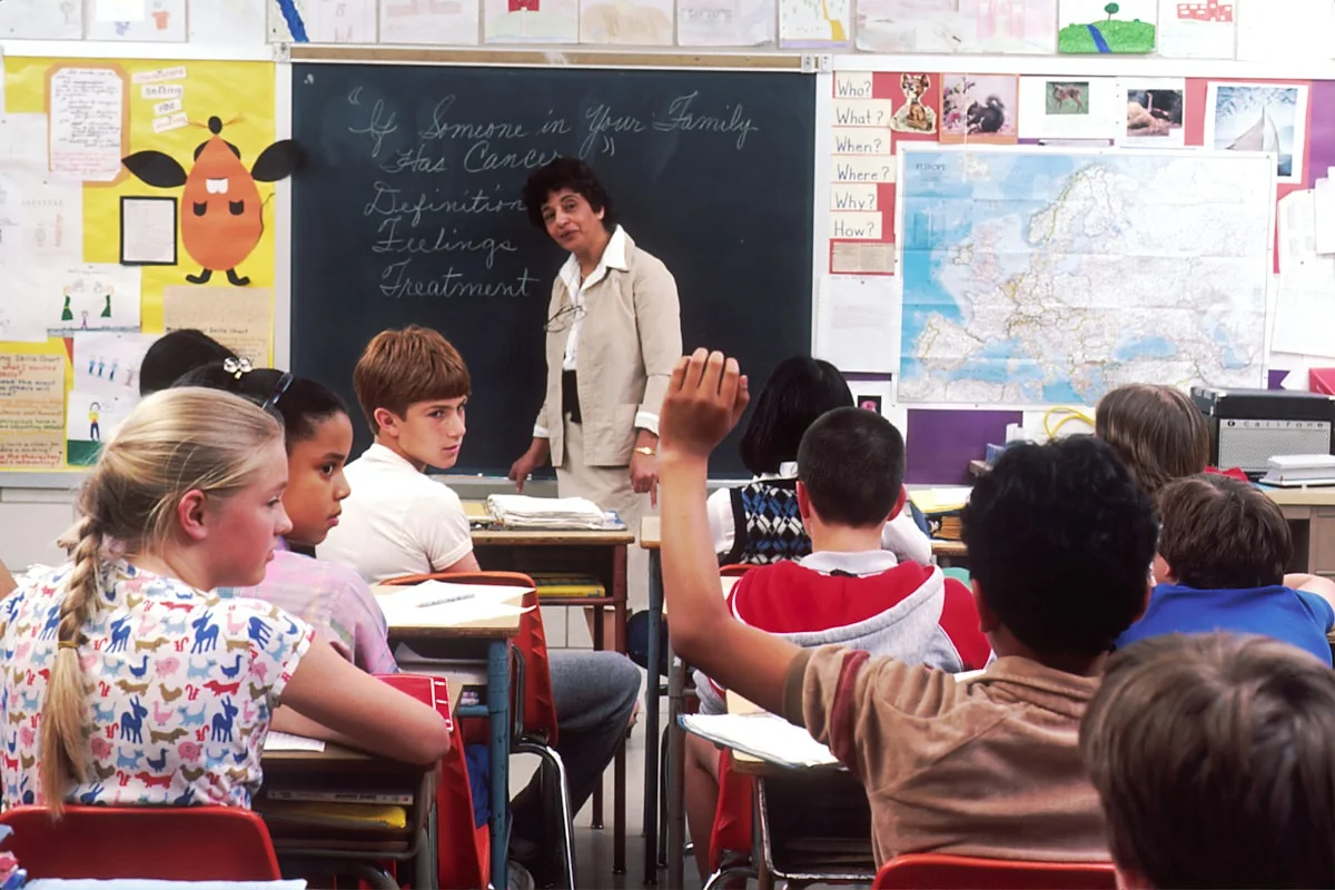 Instructor guiding students in an international classroom